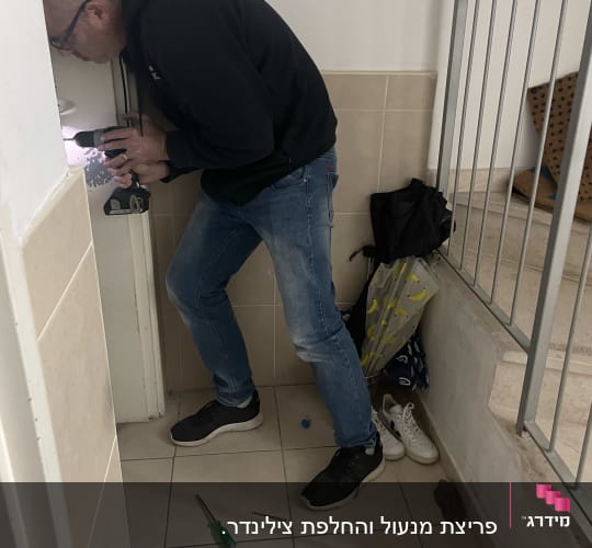 אדם קודח בדלת עם מקדחה חשמלית